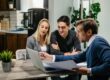 California couple meeting with a licensed mortgage broker to review pre-approval documents on a laptop