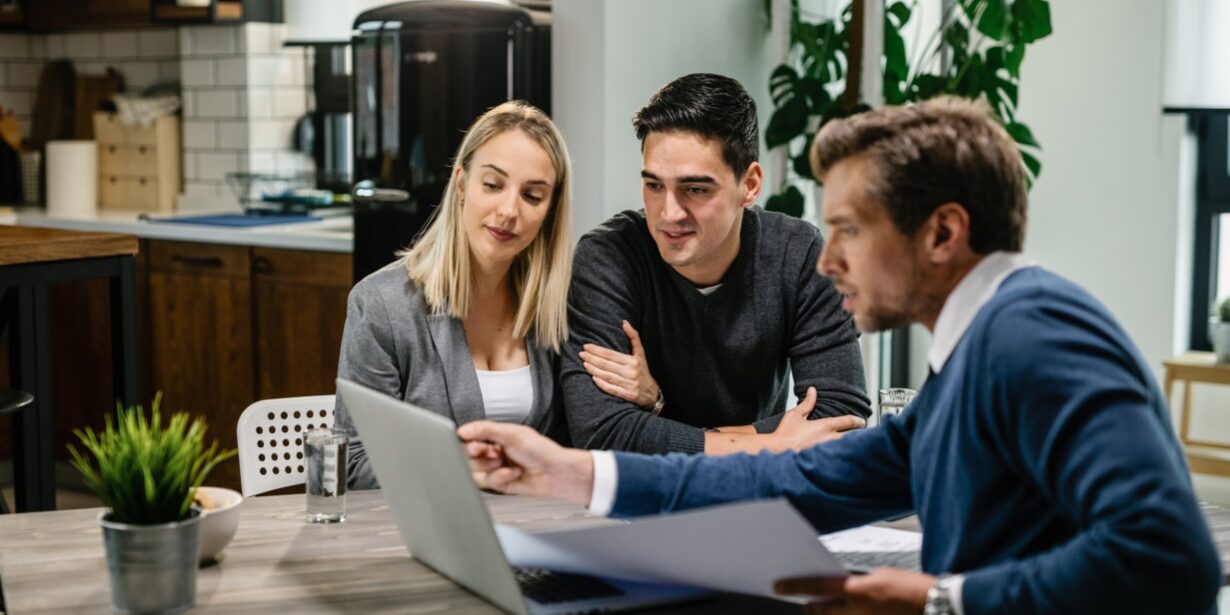How to Get Pre-Approved for a Mortgage in California – First-Time Buyer Document Review California couple meeting with a licensed mortgage broker to review pre-approval documents on a laptop