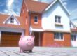 Pink piggy bank in front of a two-story brick home, representing home equity savings