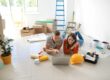 California couple using a laptop to calculate how much house they can afford with their mortgage broker