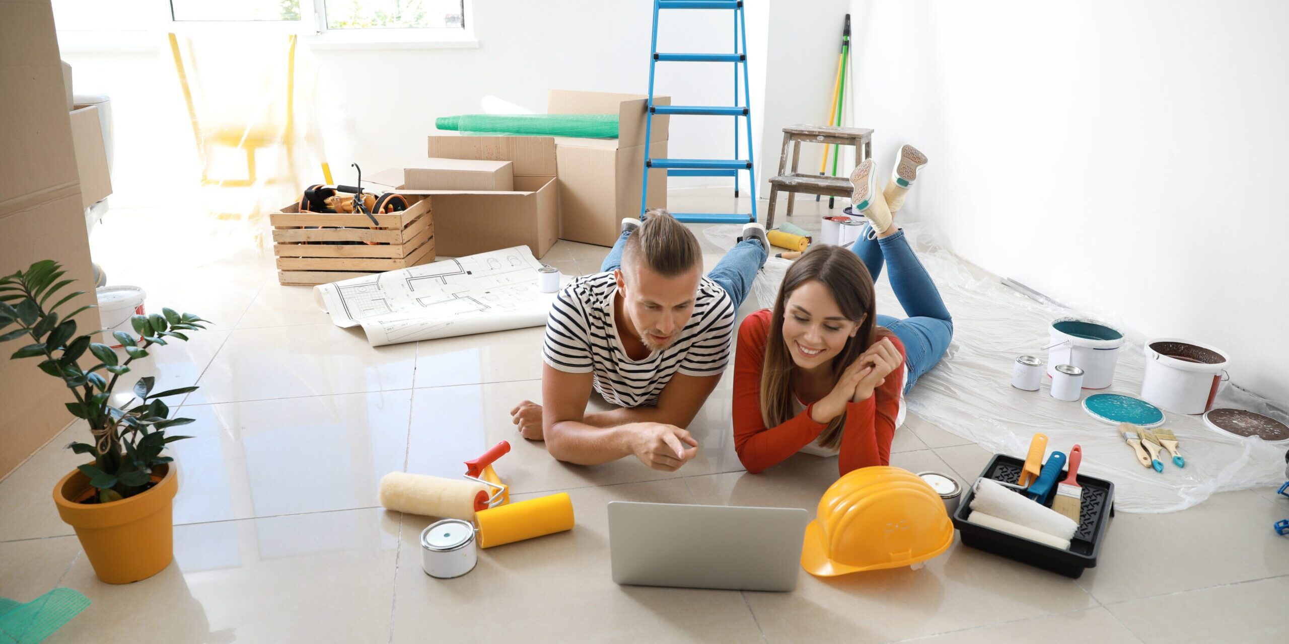 California couple using a laptop to calculate how much house they can afford with their mortgage broker
