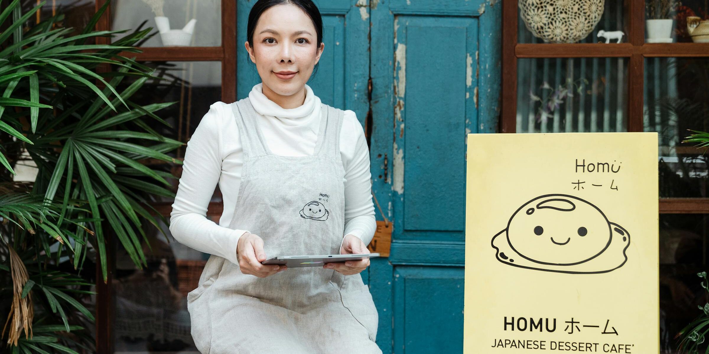 California self-employed small business owner outside her café — the kind of borrower a bank statement loan is designed for