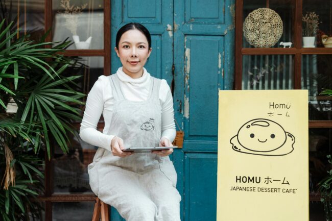 California self-employed small business owner outside her café — the kind of borrower a bank statement loan is designed for