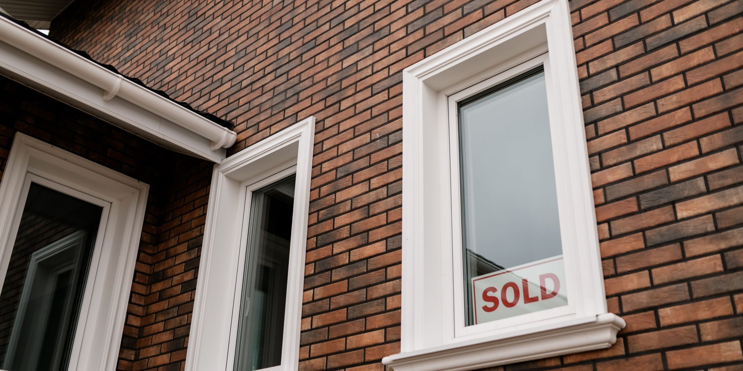 Sold sign in the window of a home — first-time buyer just closed