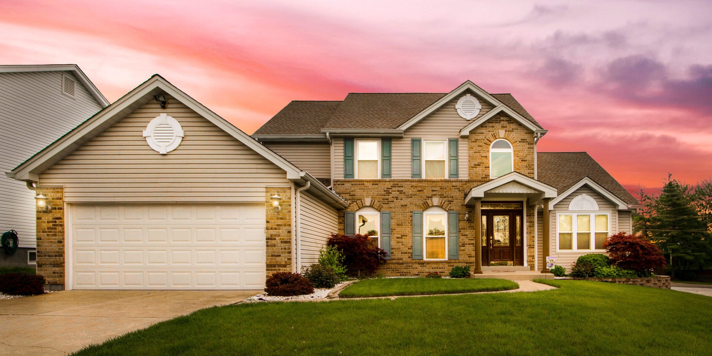 Modern suburban two-story home at sunset