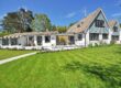 Suburban Cape Cod-style home with green lawn — typical Maryland suburban dwelling