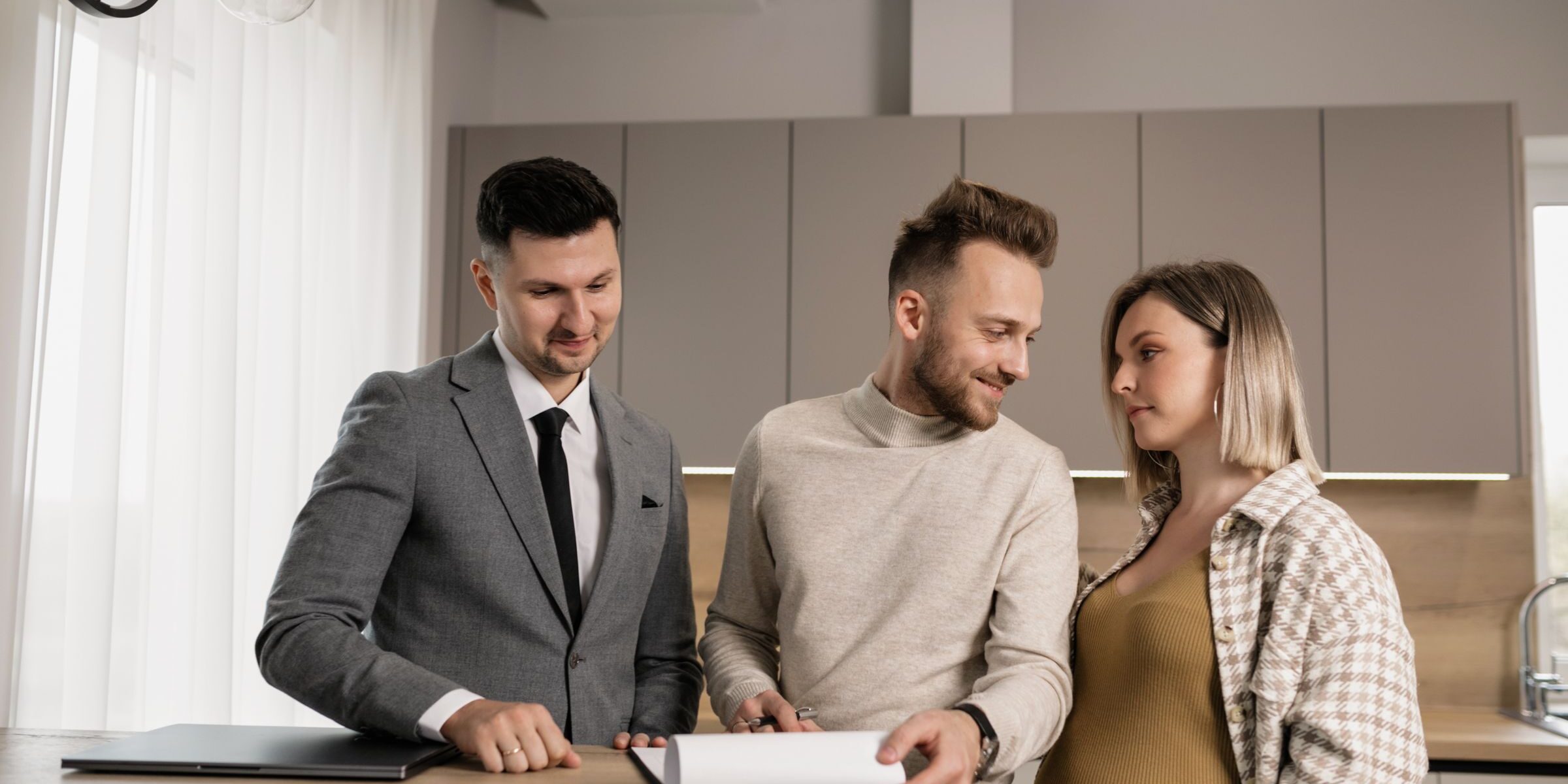 Young Texas couple reviewing home purchase documents with their broker