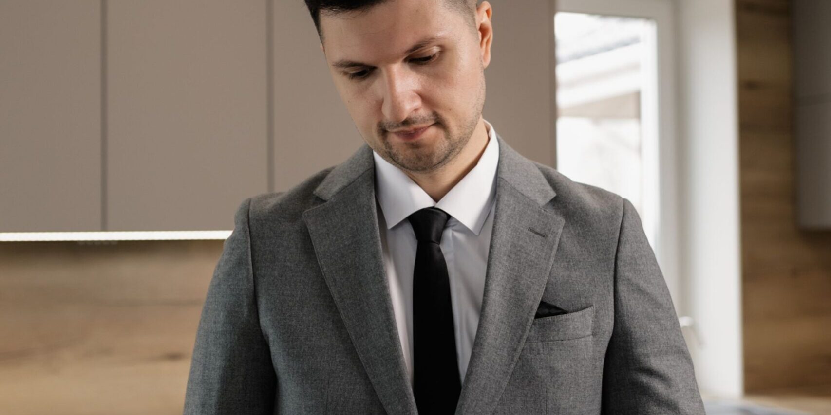 Real estate professional reviewing closing documents in a modern kitchen