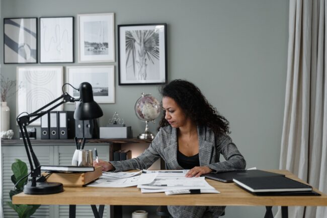 Maryland self-employed professional reviewing documents at a home office desk