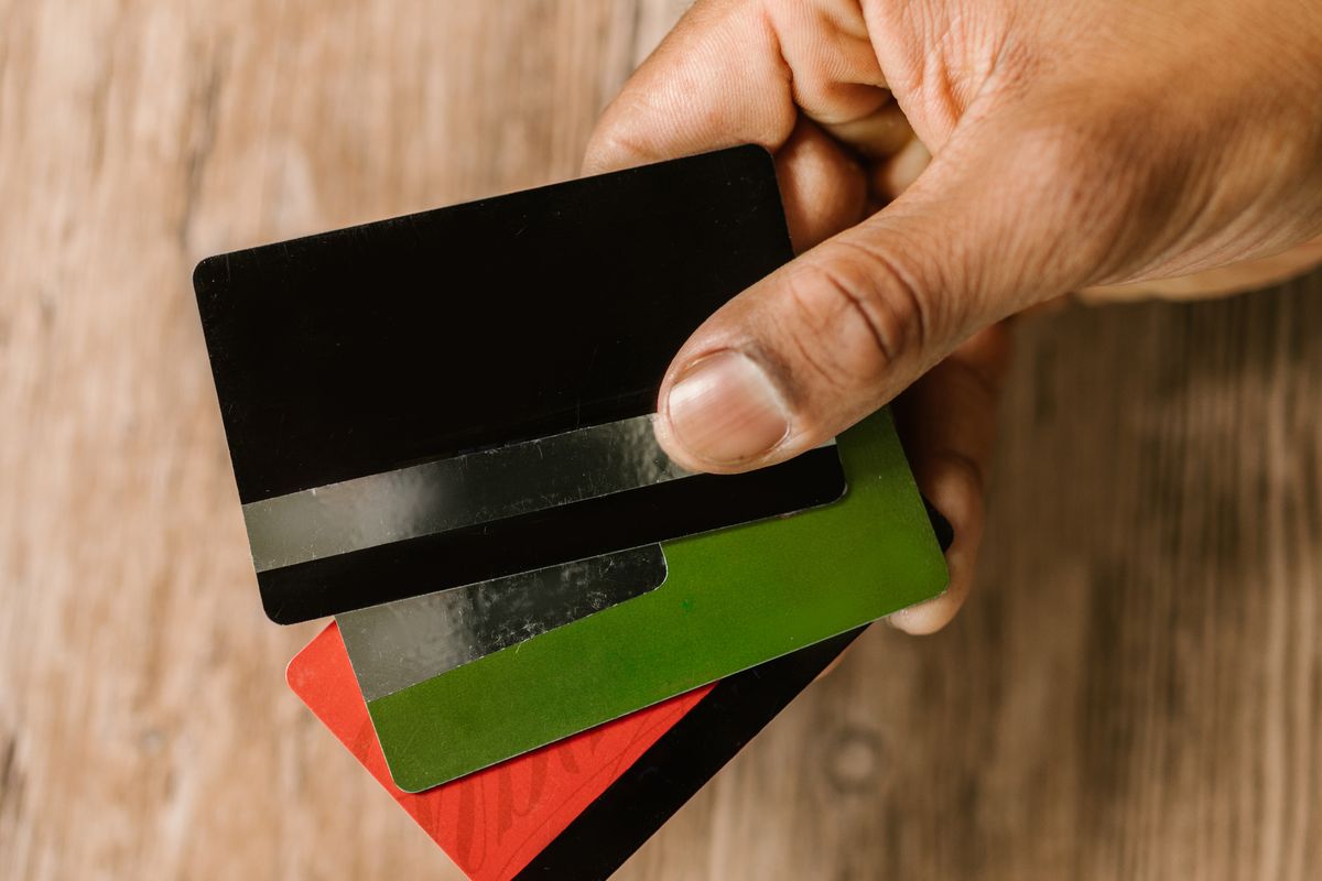 Homeowner holding multiple credit cards, ready to consolidate high-interest credit card debt with a HELOC from OnPoint Mortgage Pro