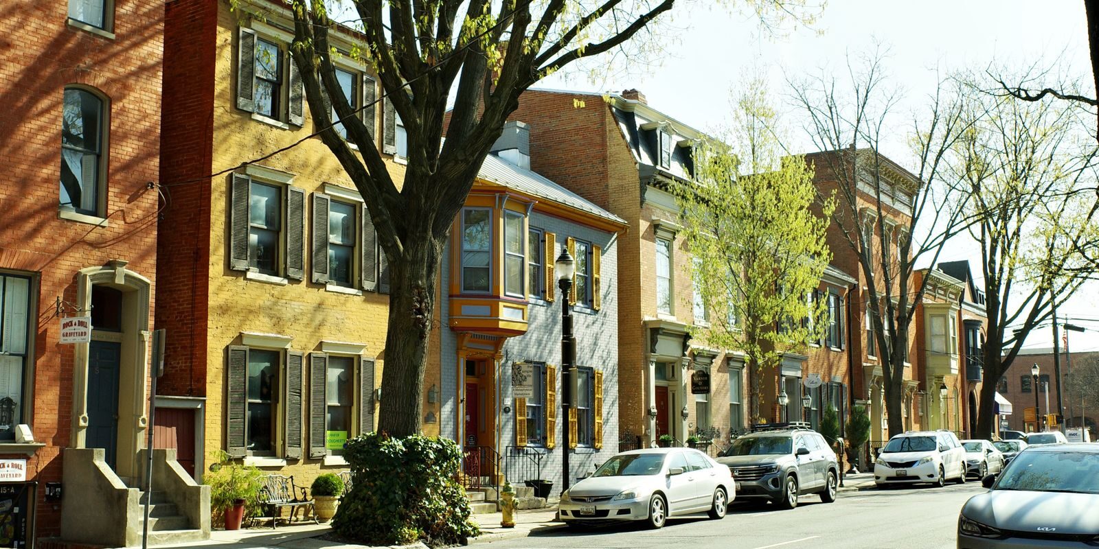 Maryland Frederick Row Houses – HELOC 2026 Historic Maryland row houses in Frederick under blossoming trees, representing the distinctive MD residential architecture where homeowners access equity through HELOCs