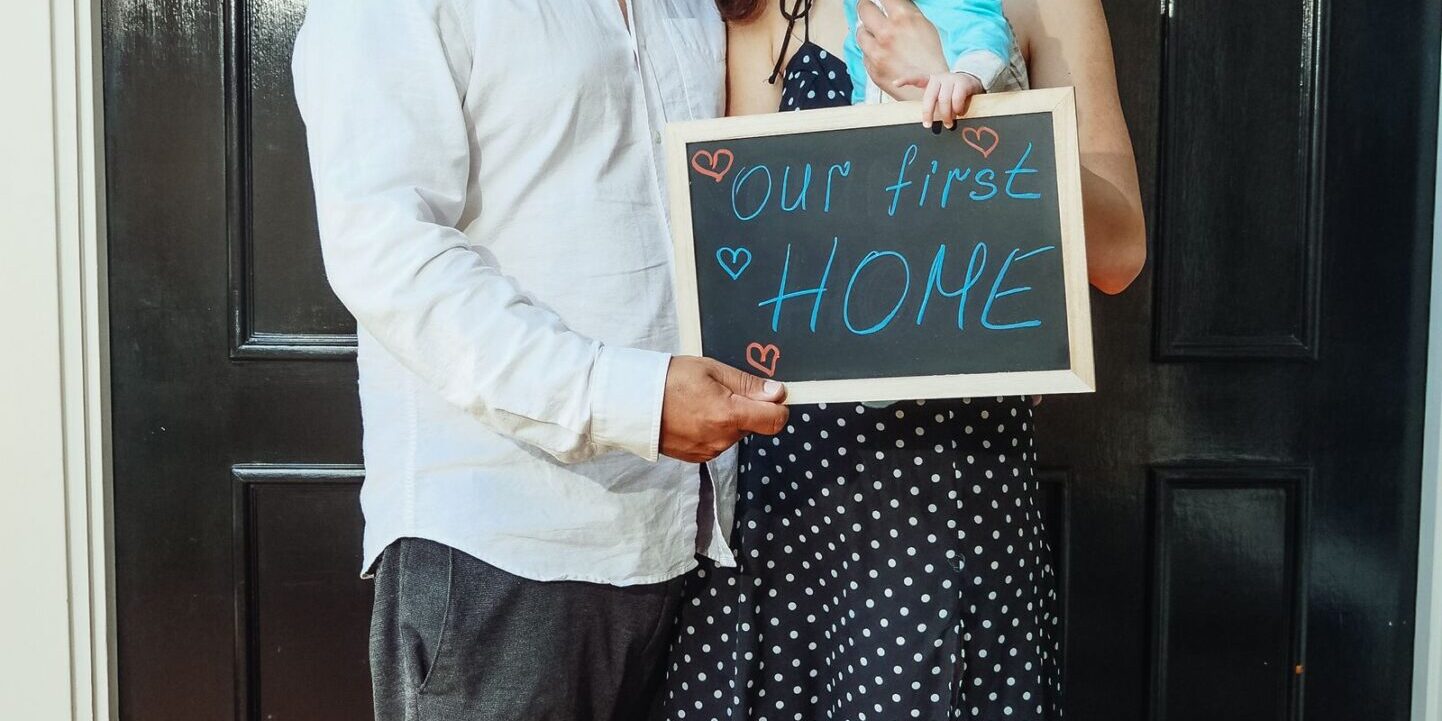 fha-streamline-refi-family-first-home-2026 Young family with baby at their first home, representative of the typical FHA borrower demographic considering an FHA Streamline refinance in 2026