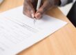Pen poised over mortgage document, representing the rate lock decision facing buyers and refinancers ahead of the September 15-16 FOMC meeting