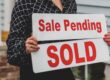 Real estate contract signing at closing table representing buyer and seller negotiating seller concessions