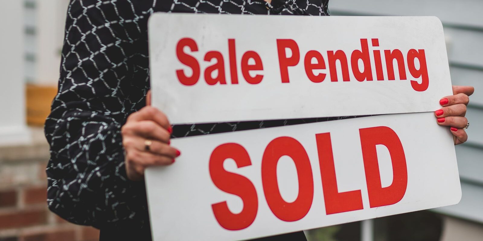 Real estate contract signing at closing table representing buyer and seller negotiating seller concessions