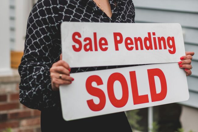 Real estate contract signing at closing table representing buyer and seller negotiating seller concessions