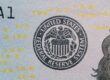 US Federal Reserve seal on currency with digital numbers overlay — hawkish dissent hike risk visualization