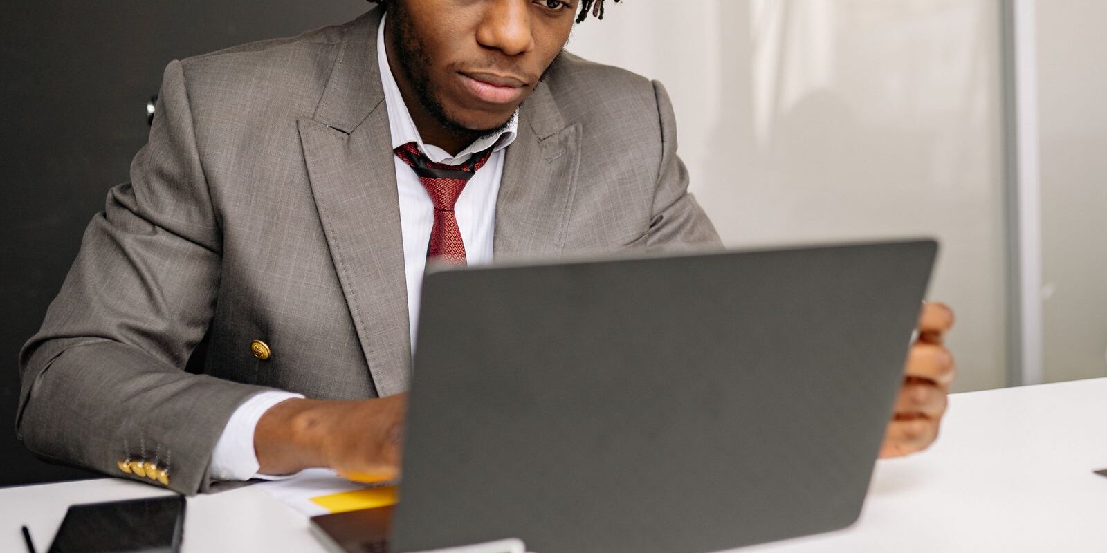 august-2026-jobs-report-mortgage-rates-reaction Focused professional analyzing the August 2026 jobs report at his laptop to determine the impact on mortgage rates and the upcoming September Federal Reserve decision