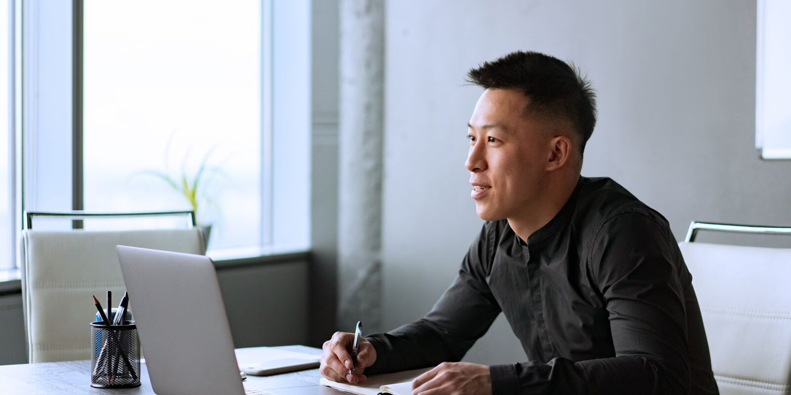 pre-fomc-rate-lock-strategy-professional-at-desk-2026 Focused young professional at his desk with laptop and notepad planning his mortgage rate lock strategy in the pre-FOMC window before the September 2026 Federal Reserve decision